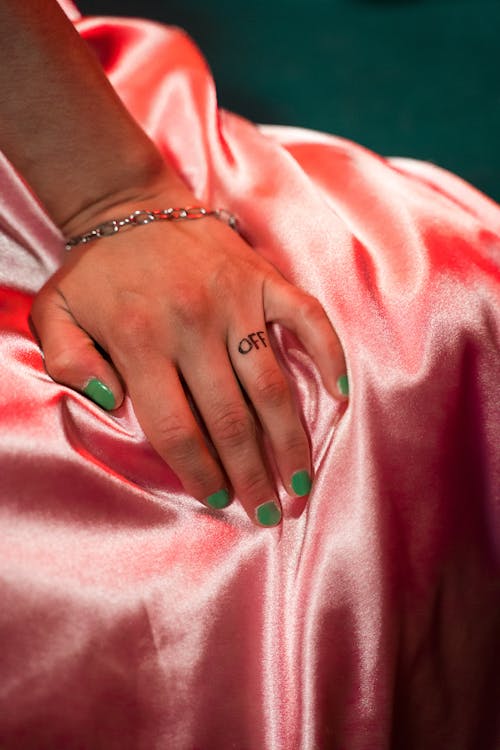 Woman's Hand on Pink Textile