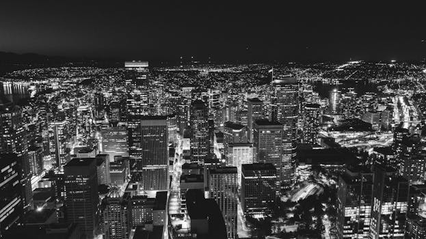 A breathtaking aerial view of Seattle's cityscape captured at night in black and white.