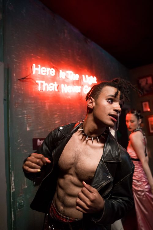 Free Muscular man in gothic attire at a neon-lit nightclub, exuding bold nightlife vibes. Stock Photo