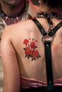 A Person with a Rose Tattoo at the Back