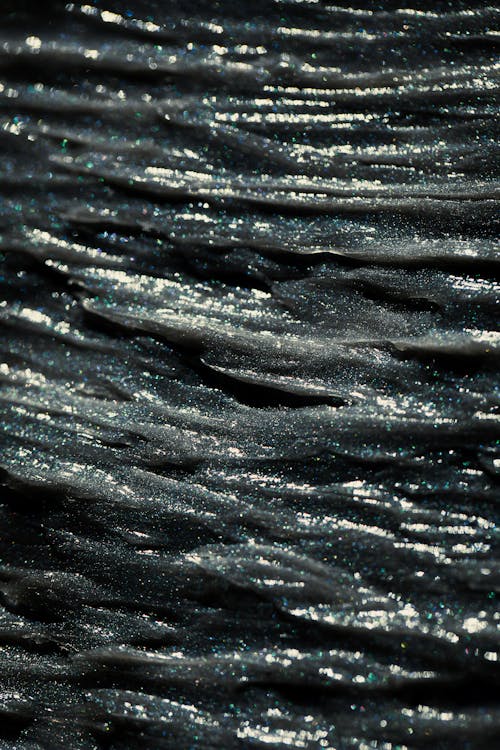 A Close-Up Shot of a Glittery Black Surface