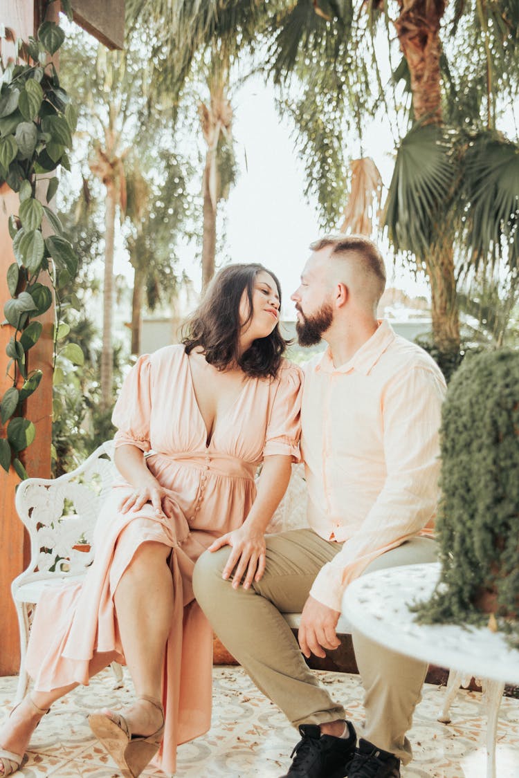 Man And Woman Sitting And Kissing