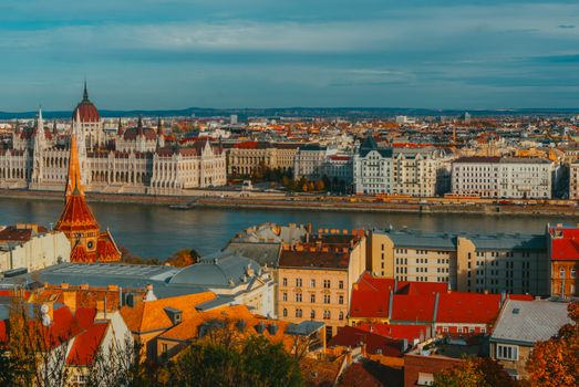 A breathtaking aerial view of Budapest featuring the Hungarian Parliament and Danube River in autumn.