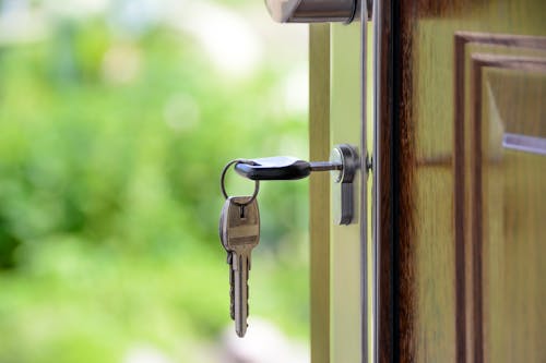 Free Black Handled Key on Key Hole Stock Photo