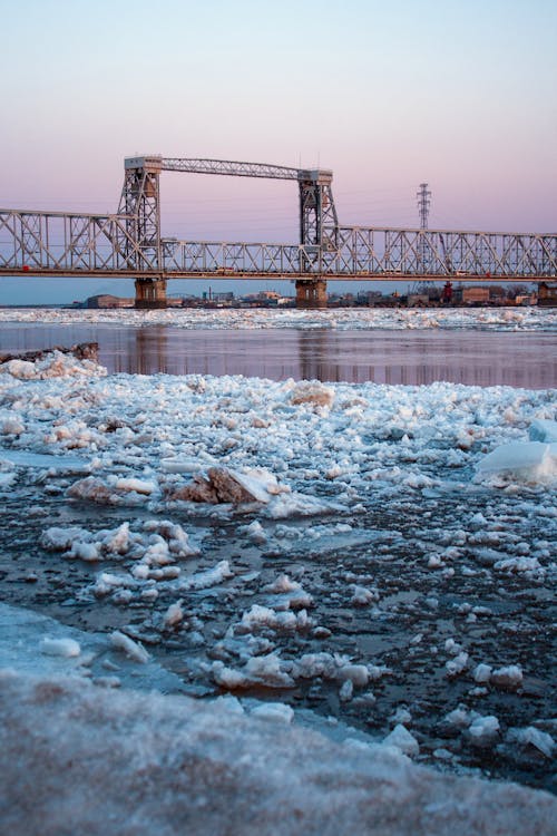 Free Metal Bridge over the Frozen Body of Water  Stock Photo