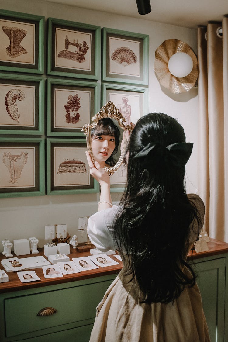 Back View Of Girl Holding A Mirror