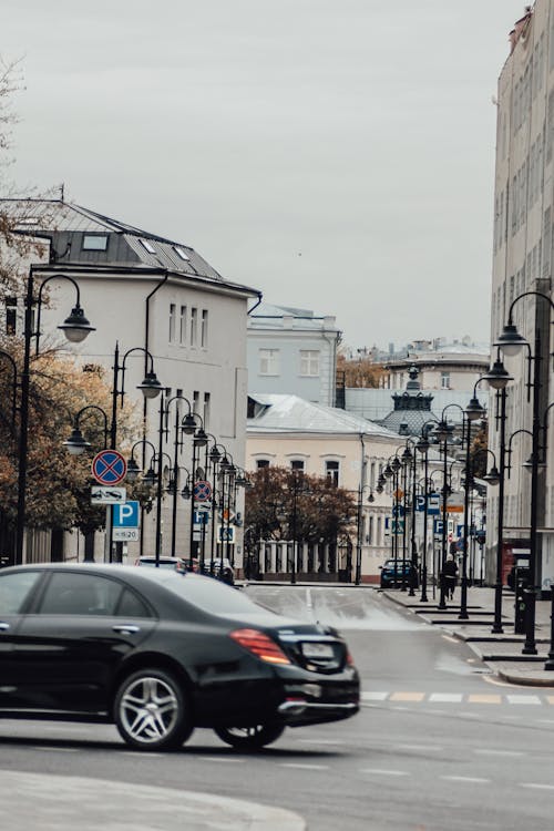 Black Car on the Road with Street Lamps