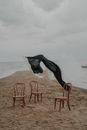 Laundry Hanging Above Chairs on Beach Shore