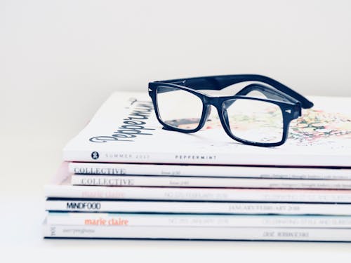 Black Framed Eyeglasses on Seven Collective Books