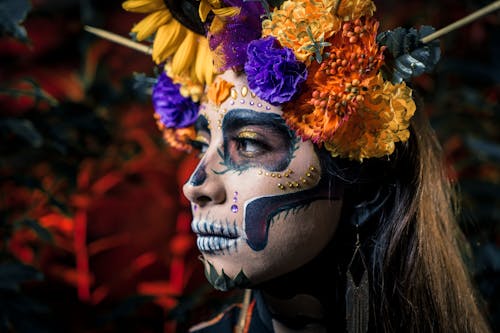 A Woman Wearing a Halloween Skull Makeup with Flower Headdress 