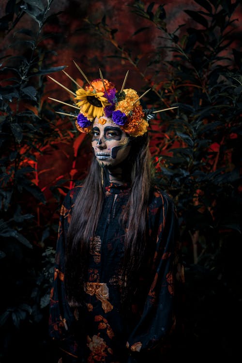 A Woman with Painted Face Wearing a Floral Headdress