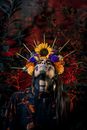 Woman in Blue and Red Floral Dress With White Skull Mask