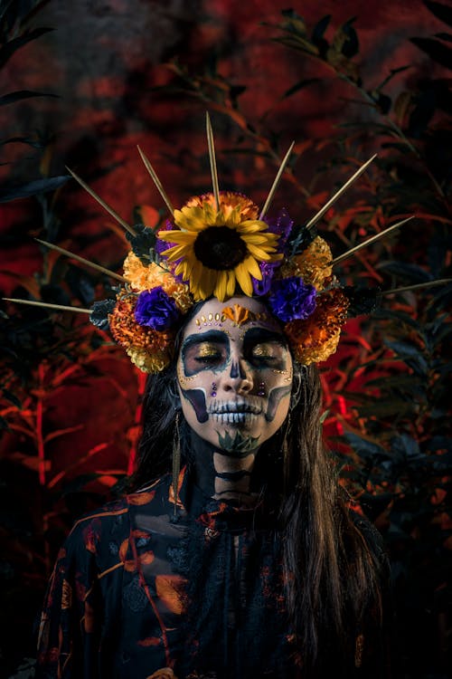 Free A Woman Wearing a Halloween Skull Makeup with Flower Headdress
 Stock Photo