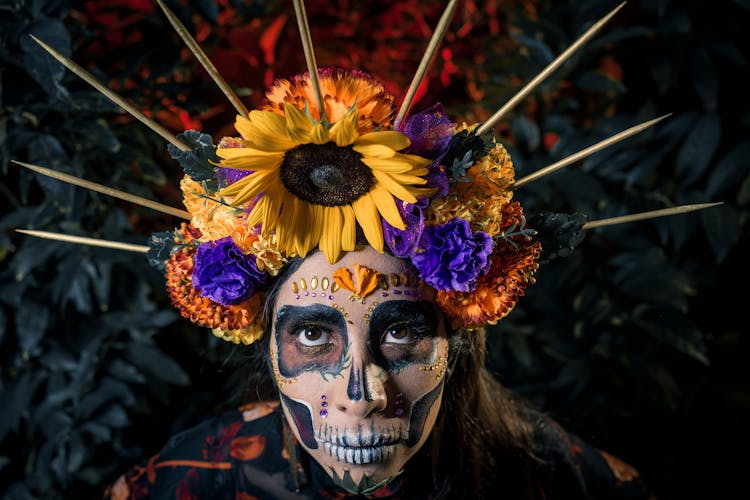 Woman With Painted Face And Wreath From Flowers