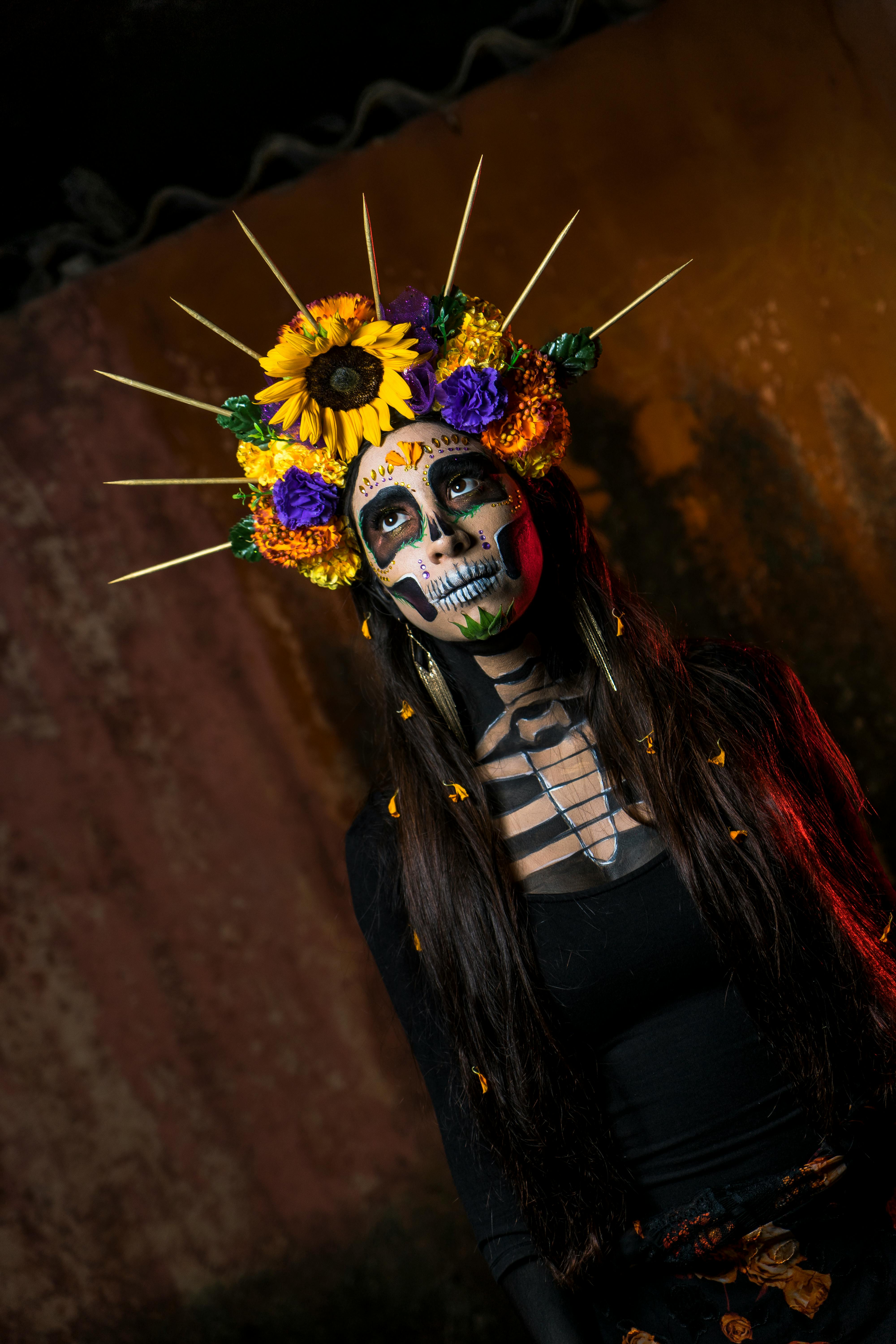 Free Colorful portrait of a woman in Dia de los Muertos makeup and floral headpiece. Stock Photo