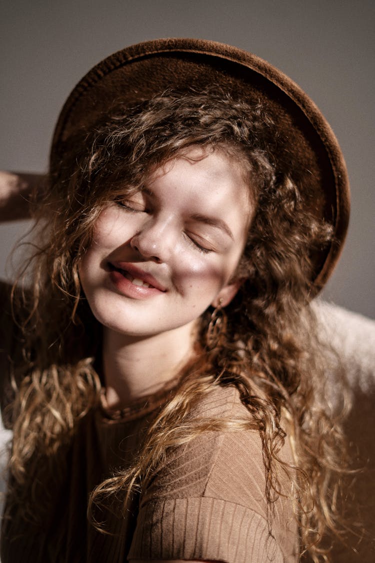 Girl With Curly Blonde Hair In Hat