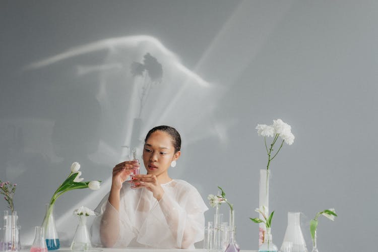 Portrait Of Woman Holding Chemistry Flask