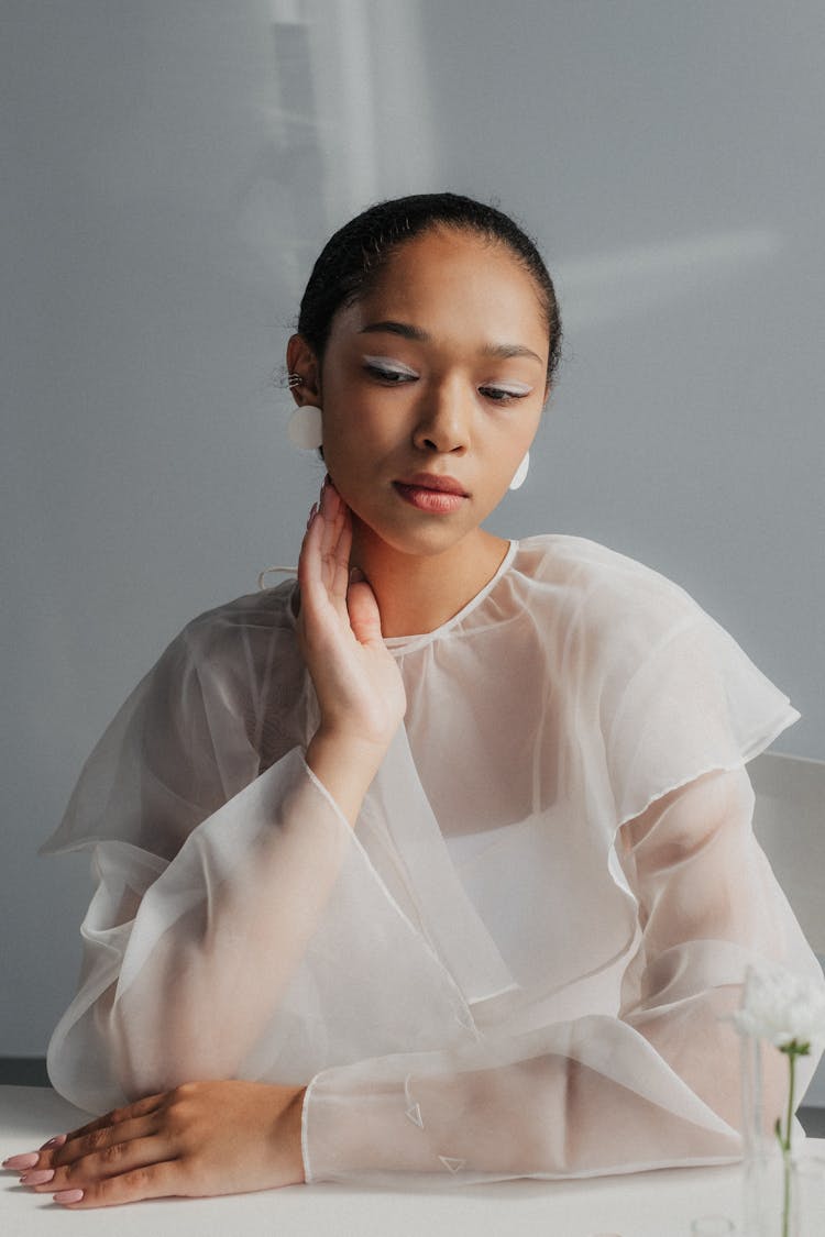 Portrait Of Black Haired Woman With Make-Up In White Cloth