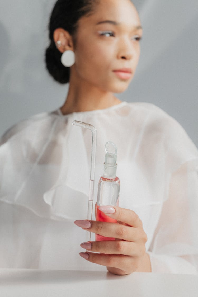 Woman Holding Test Tube In Hand