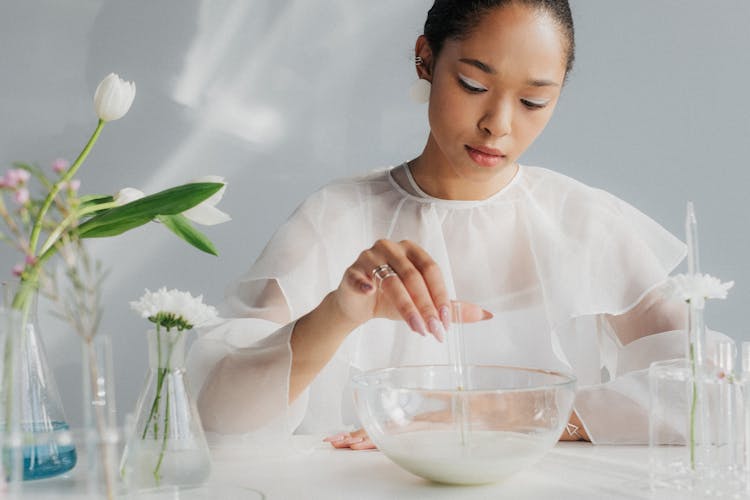 Woman In White Making Table Arrangement Looking Like Science Laboratory