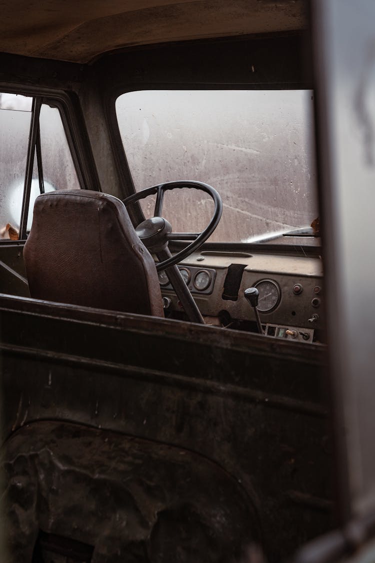 An Empty Driver's Seat In An Old Car