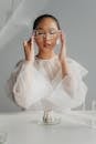 Young Woman Correcting Protective Goggles Before Making Experiment