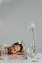 Sleeping Woman among Laboratory Glass Flasks 