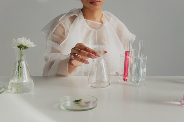 Unrecognizable Woman In Tulle Outfit Preparing Chemical Experiment In Flasks And Probe Tubes