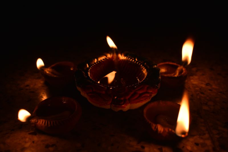 Traditional Diwali diyas casting a warm glow, symbolizing the festival of lights and spiritual warmth.