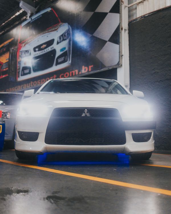Lancer Puma Modified Modified Mitsubishi Lancer in a Car Dealership · Free Stock Photo