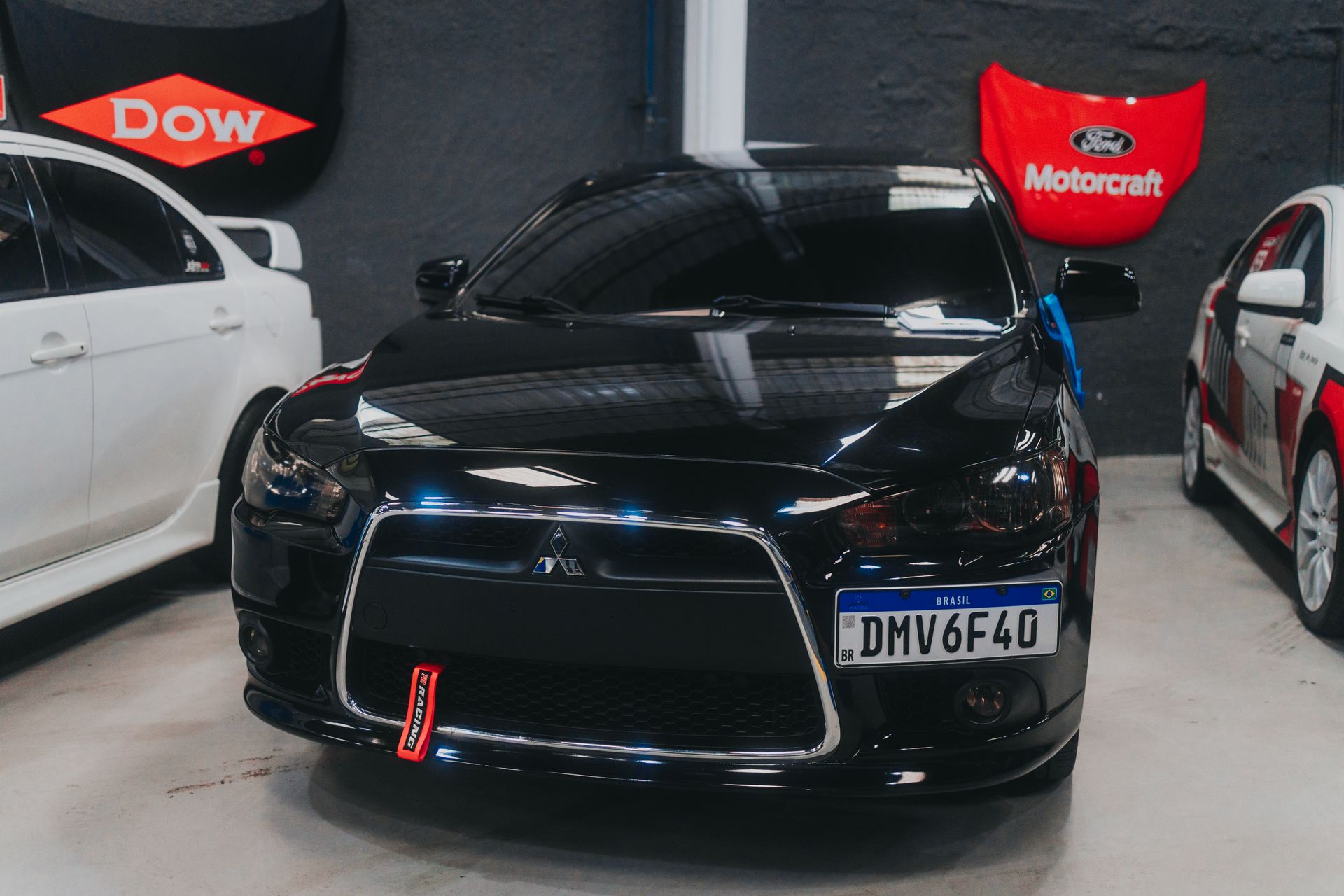 Close-up of a Mitsubishi Lancer parked indoors, showcasing sleek design and license plate.