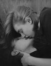 Portrait of Couple Laying in Grass Kissing