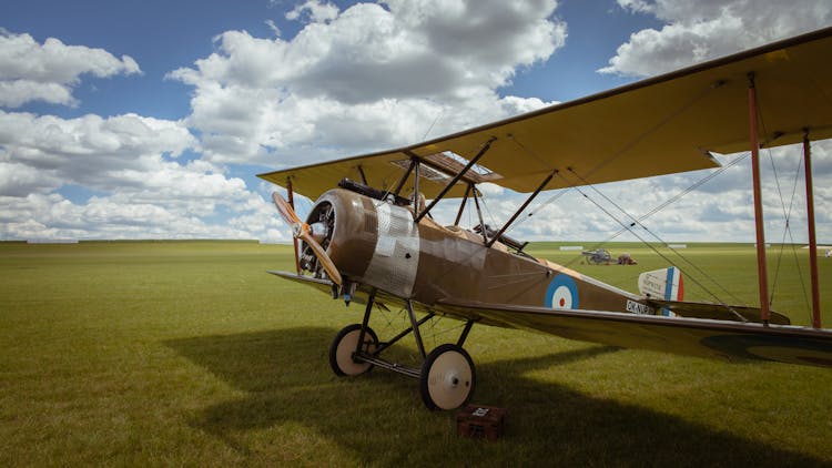 An Old Airplane In A Field