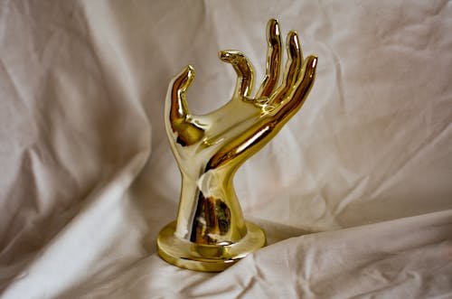 Gold Figurine on White Textile