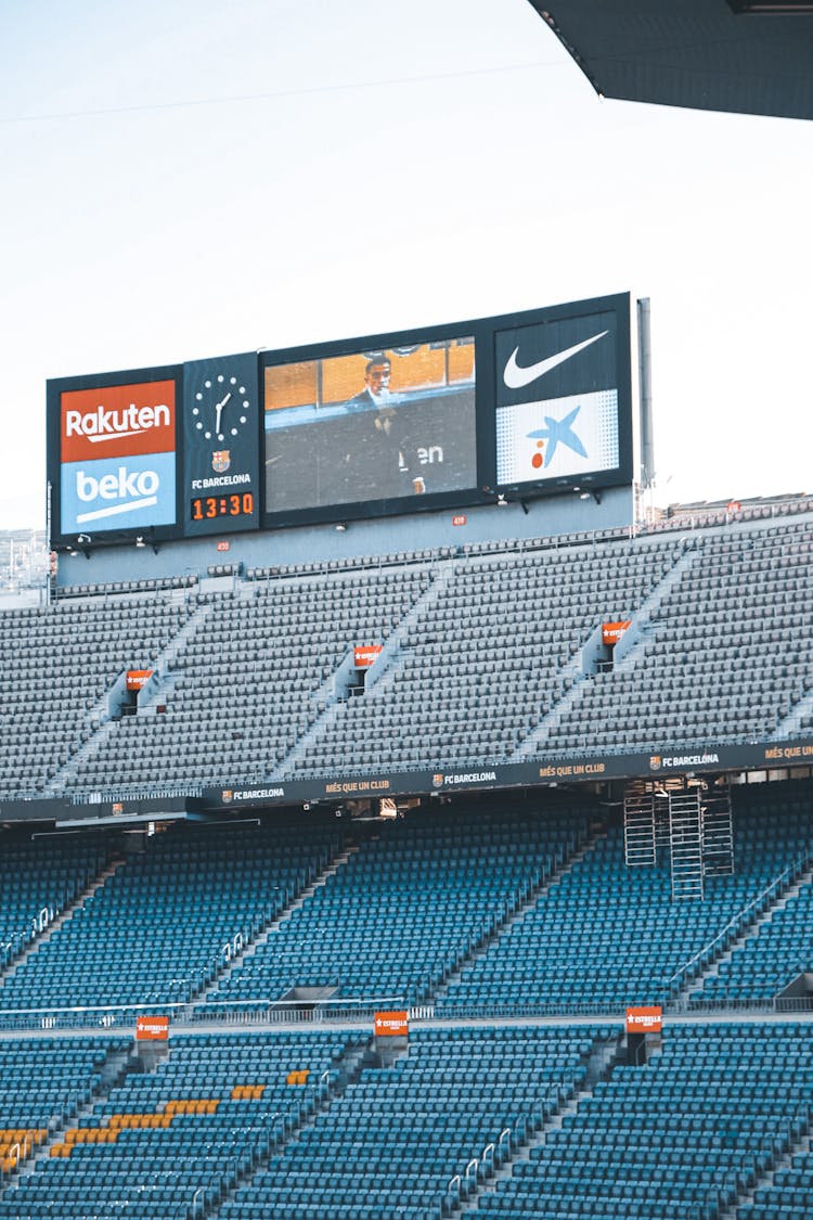 Stadium Bleachers With A Wide Screen Monitor And A Big Clock