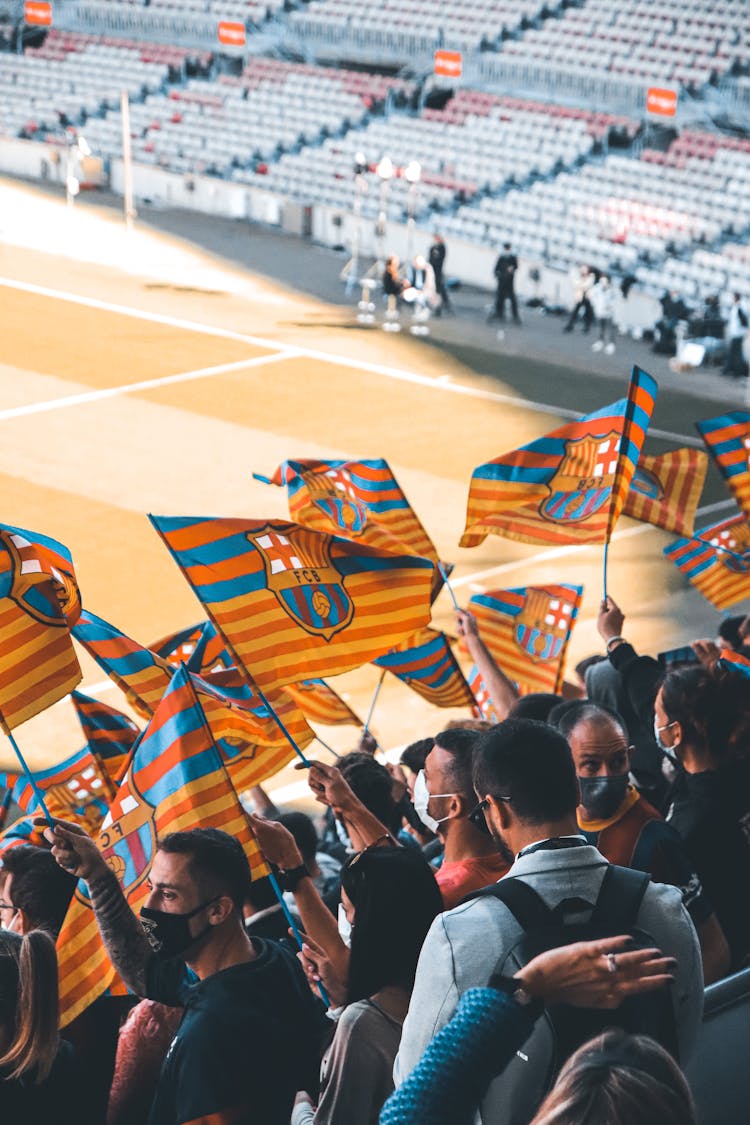 People In Face Masks Waving Flags