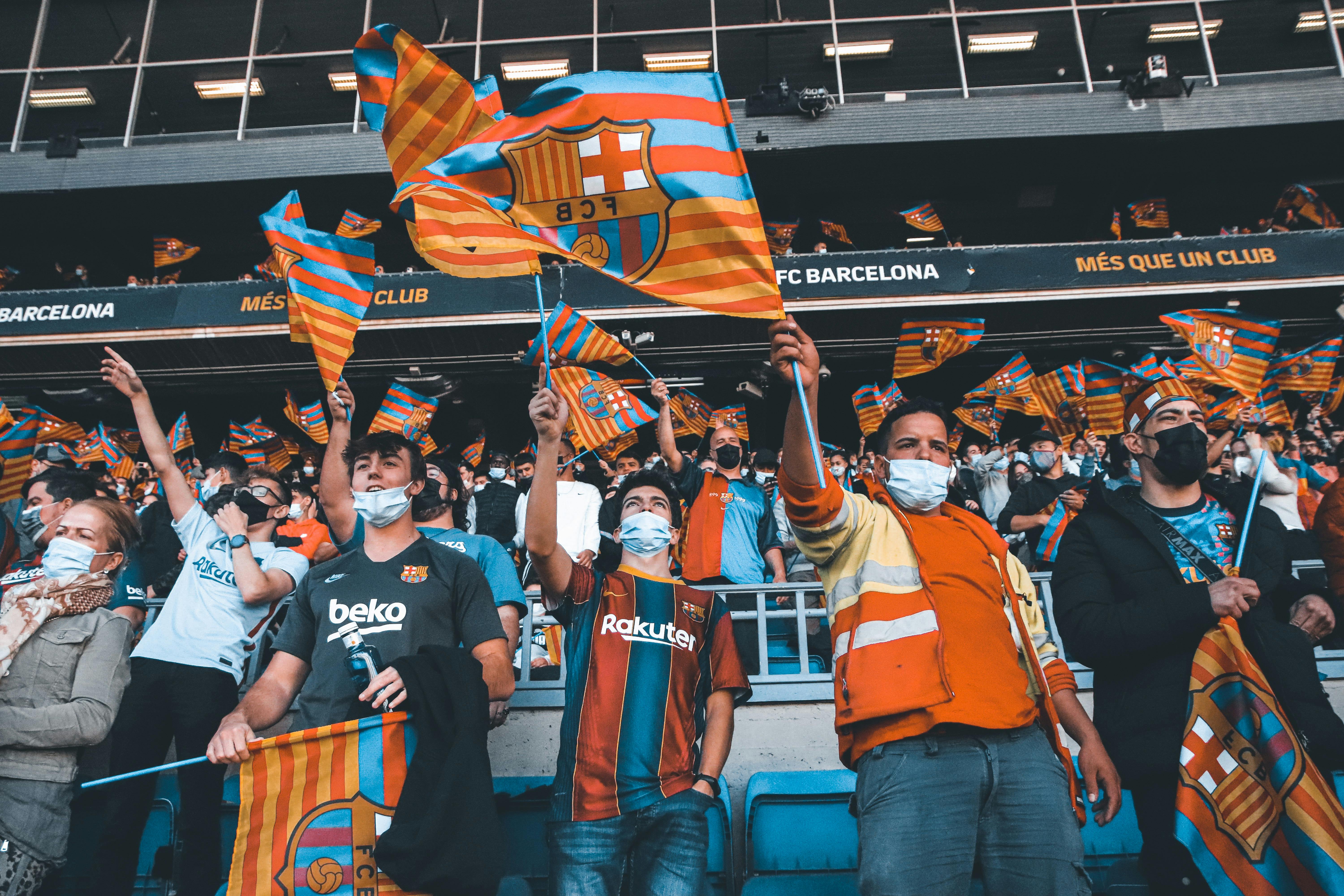 people in face masks waving flags