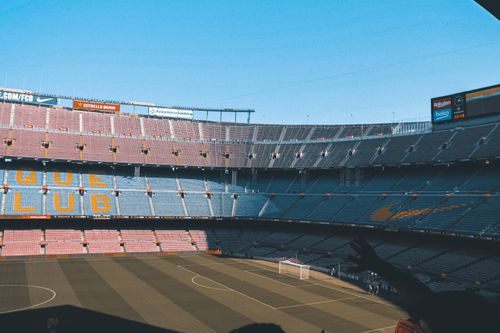 Free Wide shot of the iconic Camp Nou stadium in Barcelona, showcasing empty seats and football field. Stock Photo