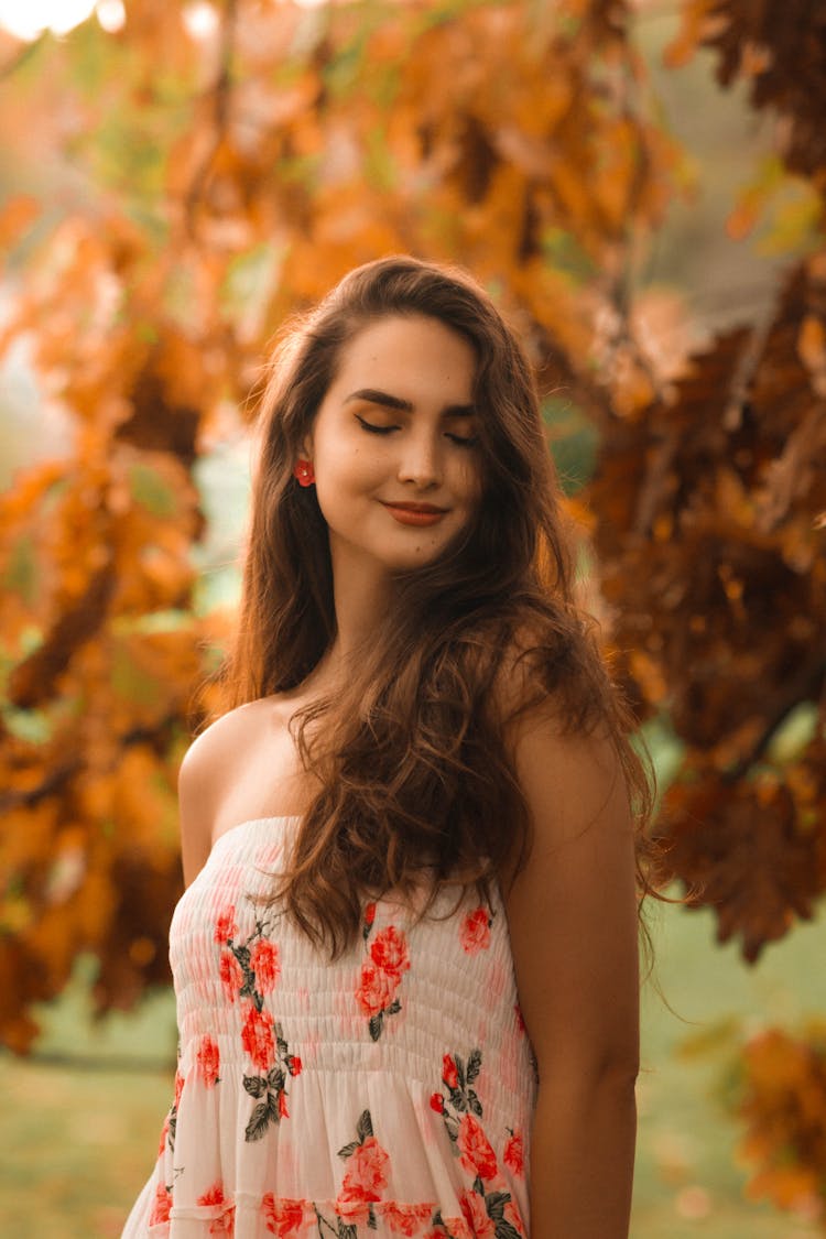 Attractive Young Woman With Log Brown Hair In Summer Dress