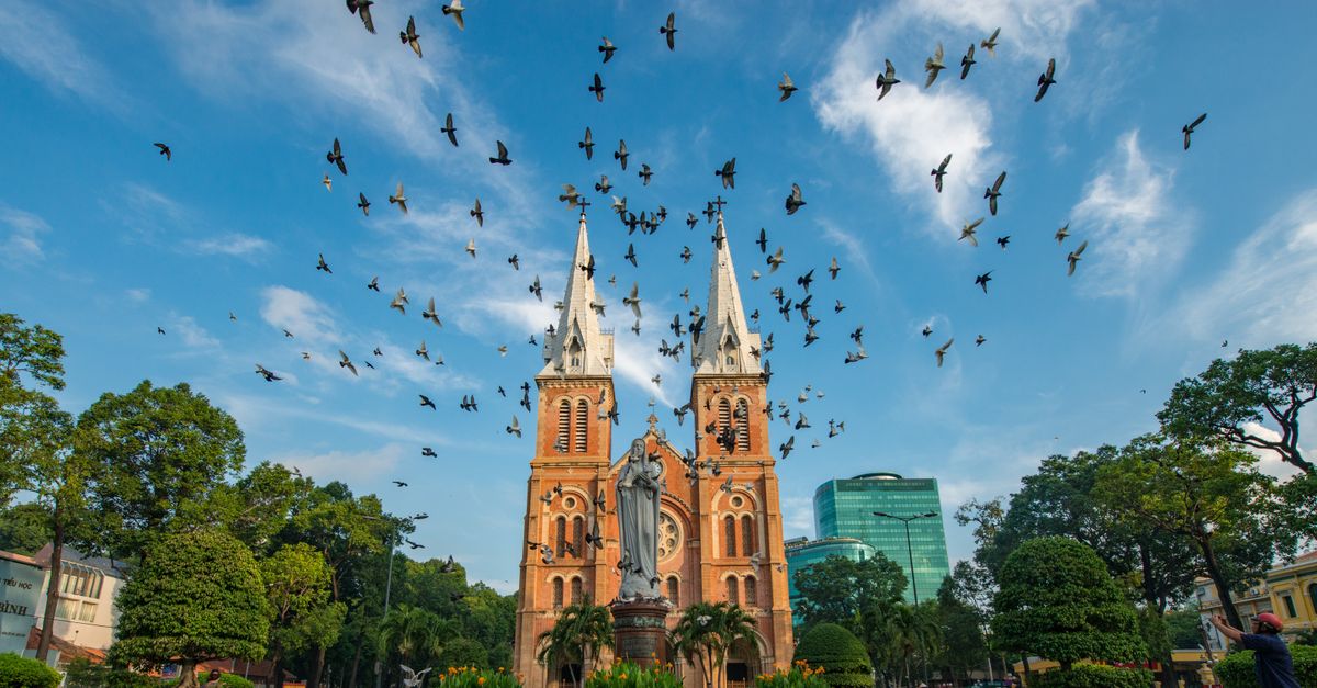 Notre-Dame Cathedral Basilica in Saigon, birds over the twin spires