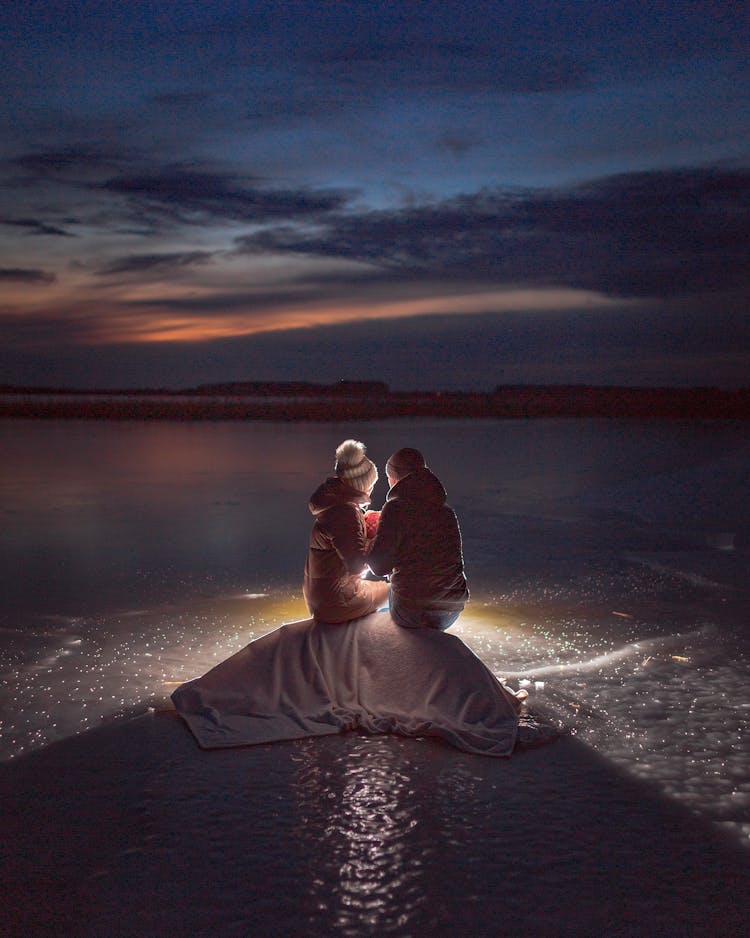 Two Girls On A Frozen Lake At Night 