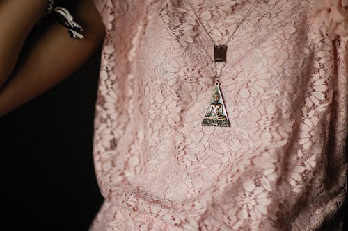 Free Person in Pink Top Wearing a Buddha Pendant Stock Photo