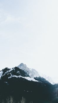 Breathtaking view of snow-capped mountains against a serene, clear sky.