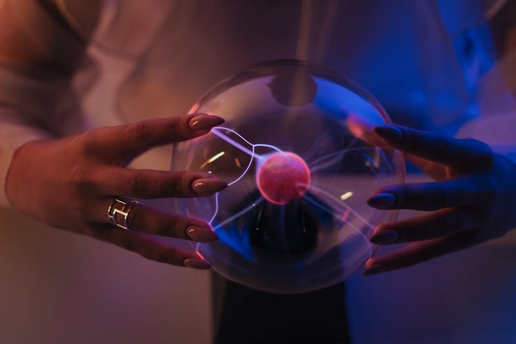 Magnetic Ball Being Held By Woman 