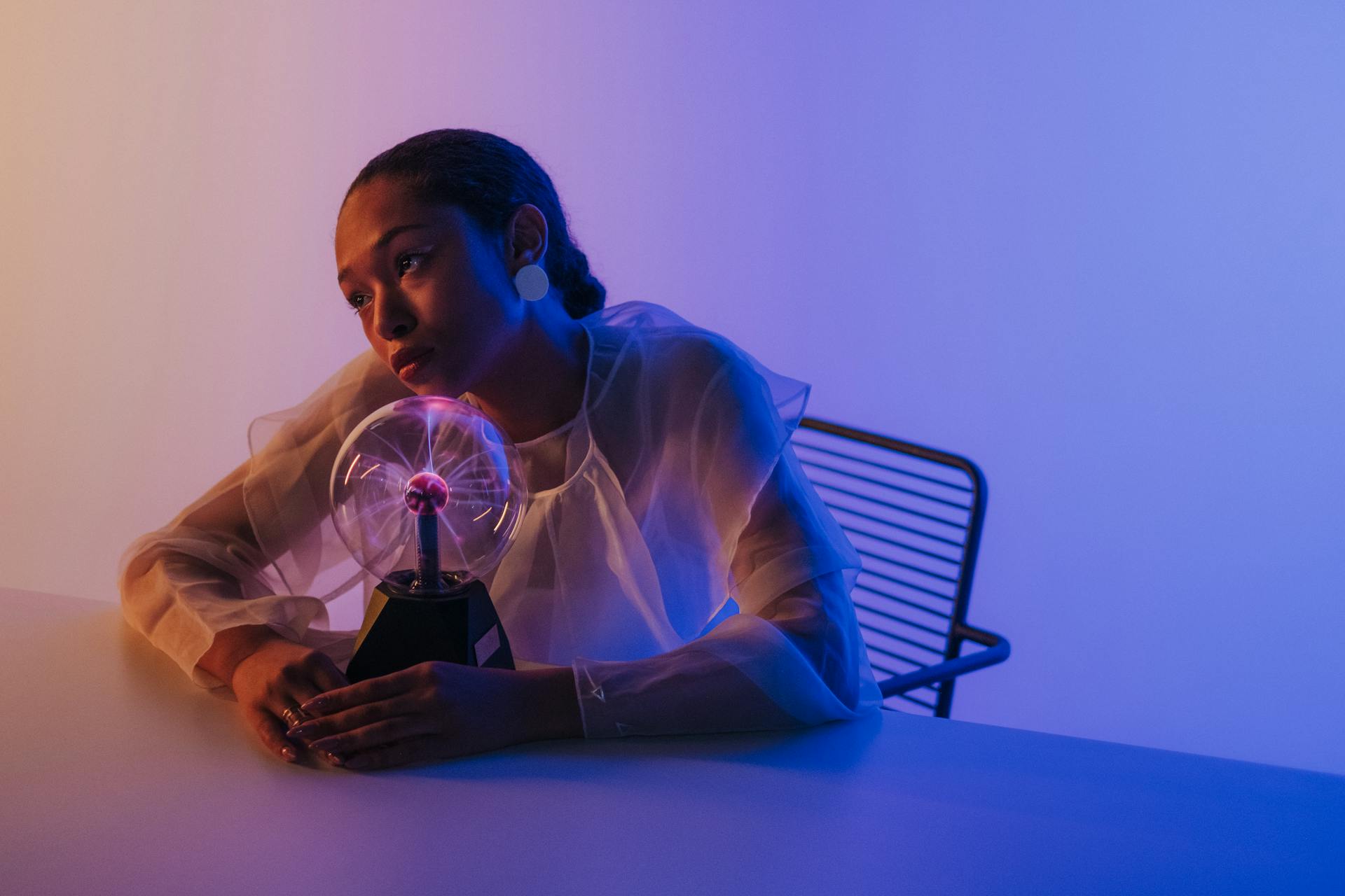 Woman Sitting with Magnetic Ball