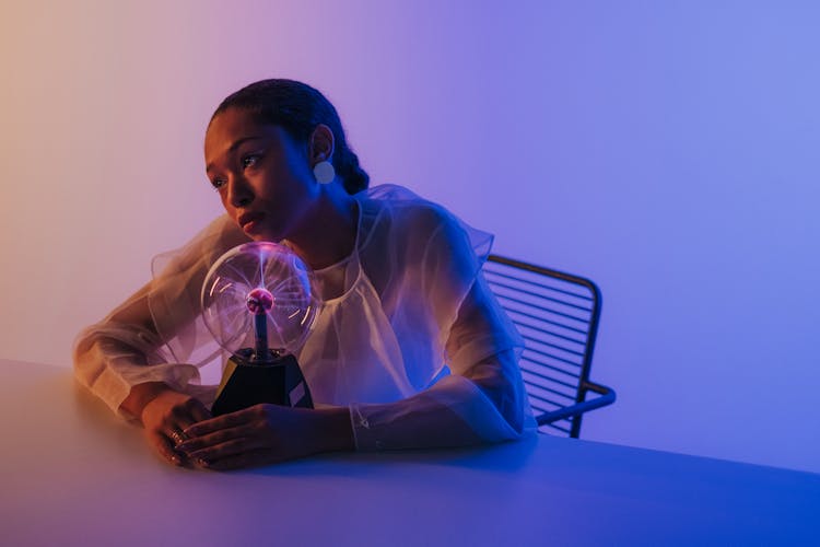 Woman Sitting With Magnetic Ball