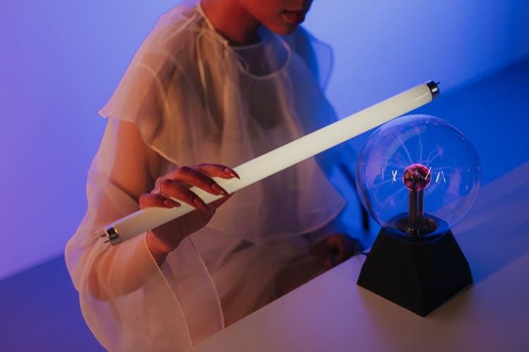 Woman Experimenting With Magnetic Ball