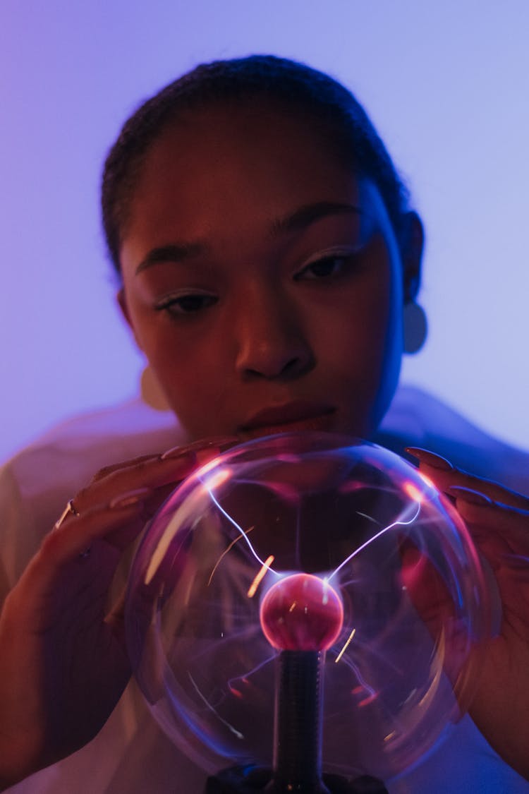 Woman Focusing On Magnetic Ball