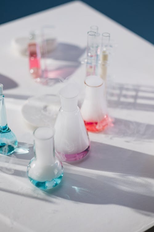 Free Liquids Boiling from Flasks on Table Stock Photo