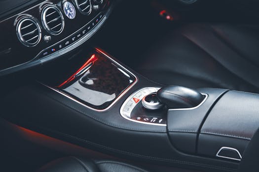 Close-up of a stylish car interior showcasing leather seats and sleek controls.